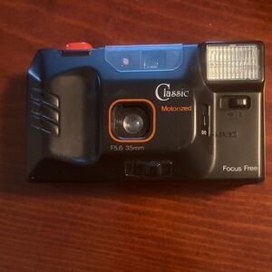 Classic Black Motorized 35mm Point-and-Shoot Camera with Orange Accents